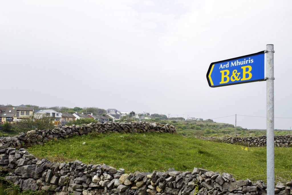 Sign leading to our B&B. If you're ever in the area, definitely stay here. It's quite lovely! Also look at the stone walls. These covered the island! 